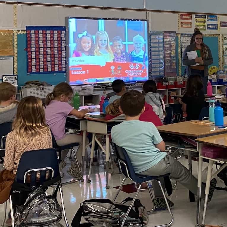 A classroom of children listening to prevention education