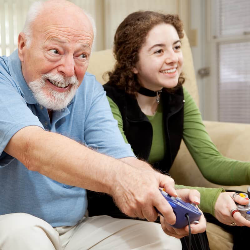 Man playing video game with his daughter